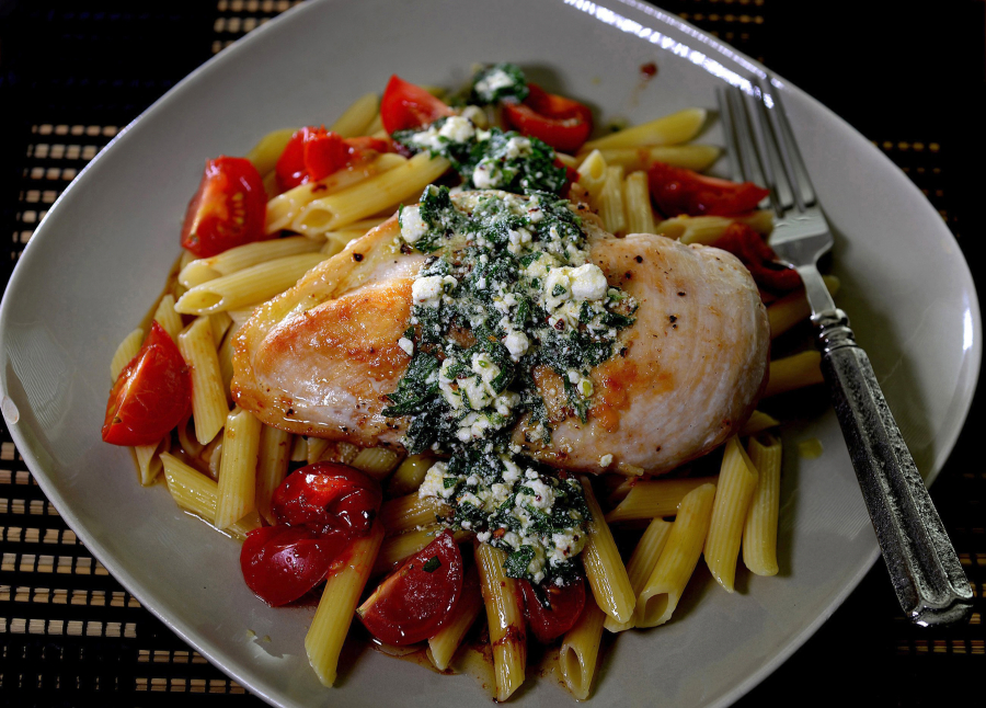 Golden brown chicken breasts top pasta with a goat cheese vinaigrette.