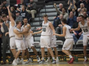 Union boys basketball players celebrate a basket in the their bi-district tournament win over Olympia last month, helping send the Titans back to the Tacoma Dome.