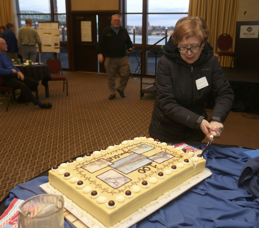 Sharon Wood Wortman, PDX Bridge Festival board member, cuts the cake at a party to celebrate the 100th anniversary of the opening of the Interstate Bridge.