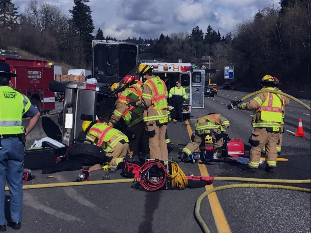 Firefighters work Thursday afternoon around an SUV involved in a two-car crash on Interstate 5 that left one driver seriously injured. The firefighters needed to cut the driver from the SUV.