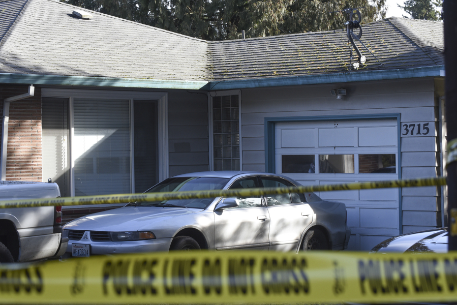 Police tape surrounds a house on East 18th Street in Vancouver on Friday. Vancouver police say a SWAT team found a dead person inside after patrol officers responded to a welfare check call.