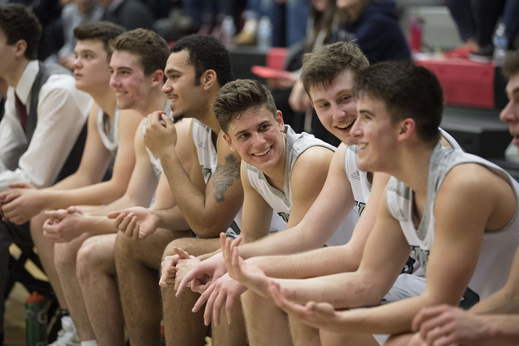 Players are all smiles on the sidelines at the end of the fourth quarter against Olympia at Union High School on Thursday night, Feb. 9, 2017.