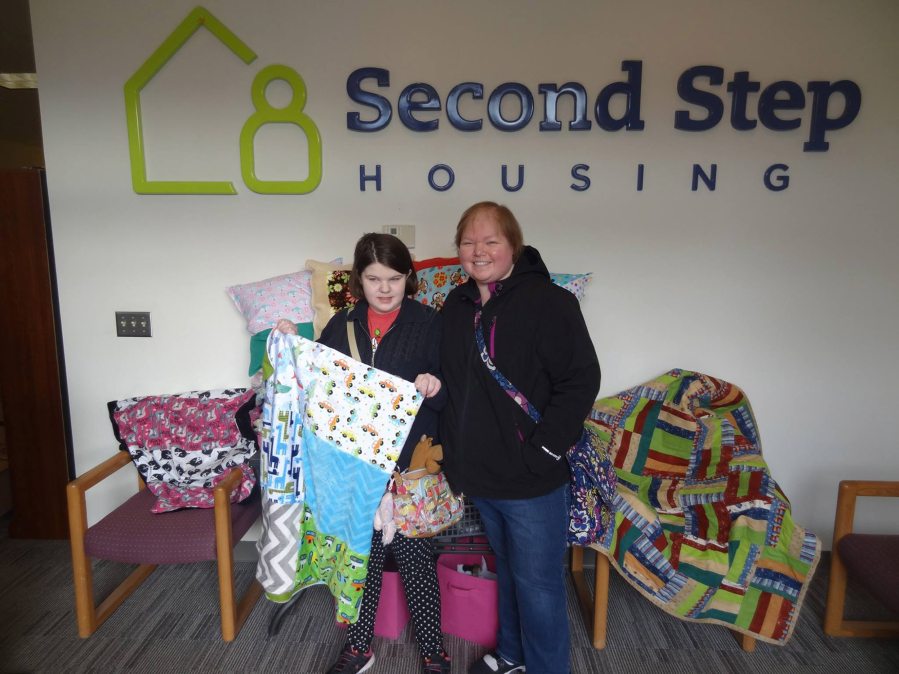 Vancouver: Lucy Crouse, 9, and her mother, Holly Crouse, donated 32 quilts to kids through Second Step Housing.