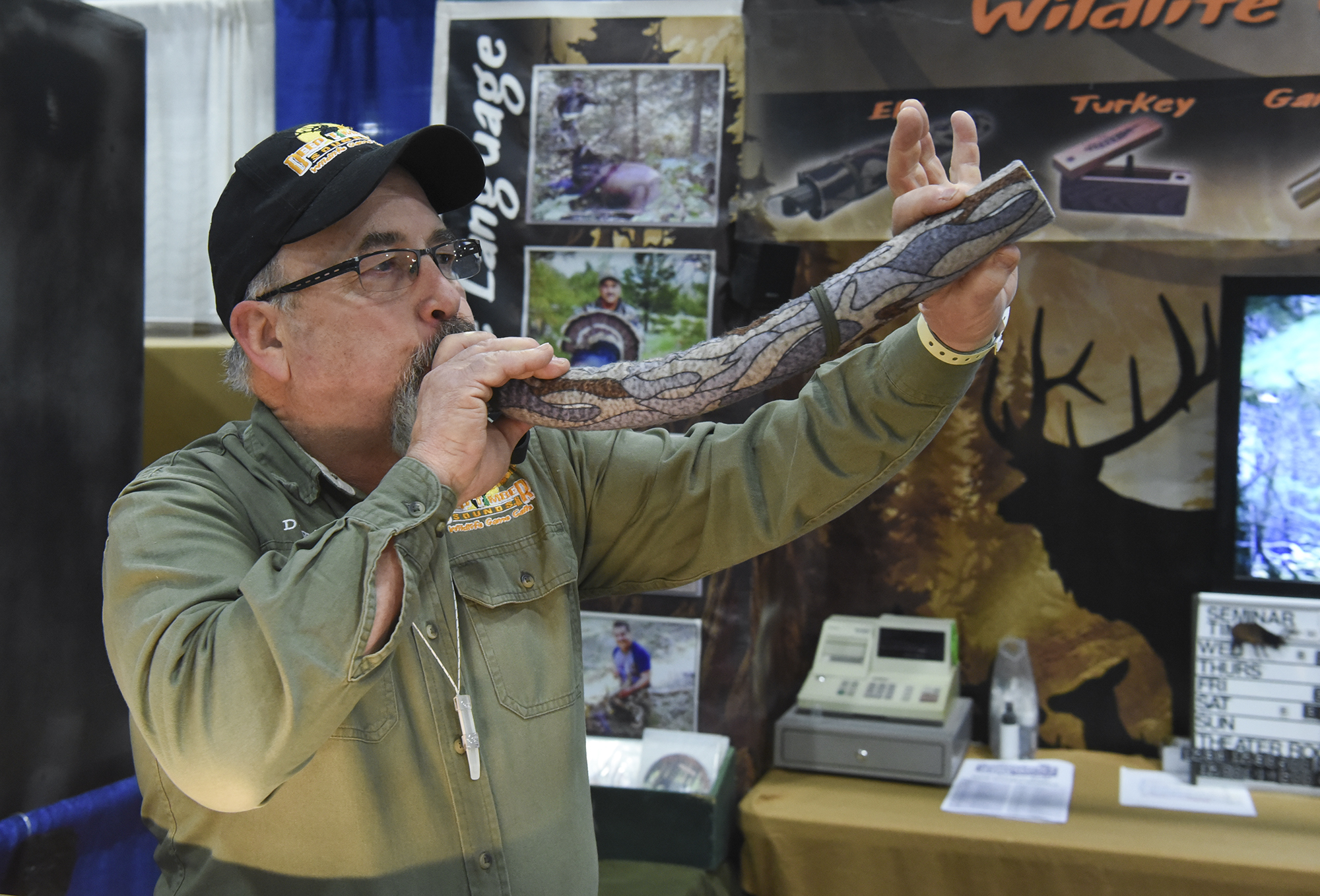 David Shaw of Deep Timber Sounds blows into a Dominator bugle elk call at the Pacific Northwest Sportsmen’s Show at the Portland Expo Center, Wednesday February 8, 2017.