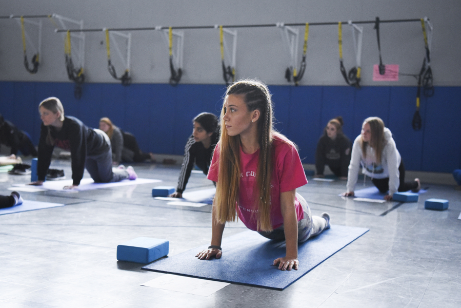 Running Start student Makayla Draper follows along in a yoga class at Clark College.