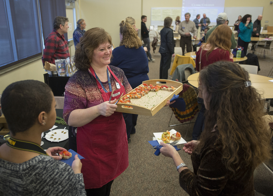 Cooking instructor Edurne Andre serves up baguette slices with cream cheese and lox to participants during Growing our Future, a food summit hosted at Clark College at Columbia Tech Center on Friday afternoon.