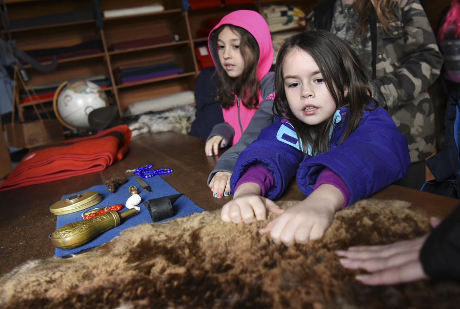 Lillyannah Cook-Forsht, a Washington Connections Academy student, right, feels an animal pelt, while Iris MacMichael waits for a turn.
