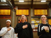 Rick Stover is flanked by Prairie senior Grace Prom, left, and Hudson&#039;s Bay senior Sharon Hanson during the national anthem before a basketball game at Prairie on Thursday. It&#039;s tradition that started last season with players flanking Stover to help remember the sacrifice Stover&#039;s late son Chris made in service to his country.