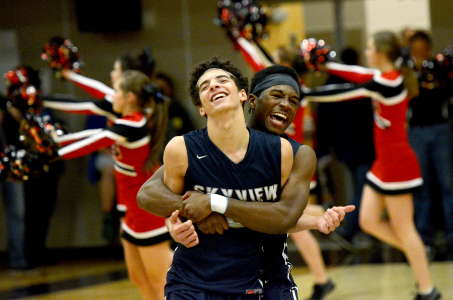 Skyview senior Levi Nickelson hugs teammate Alex Schumacher after Skyview beat Camas 45-44 at Camas High School on Wednesday, February 1, 2017. Schumacher won the game with a late three-pointer.