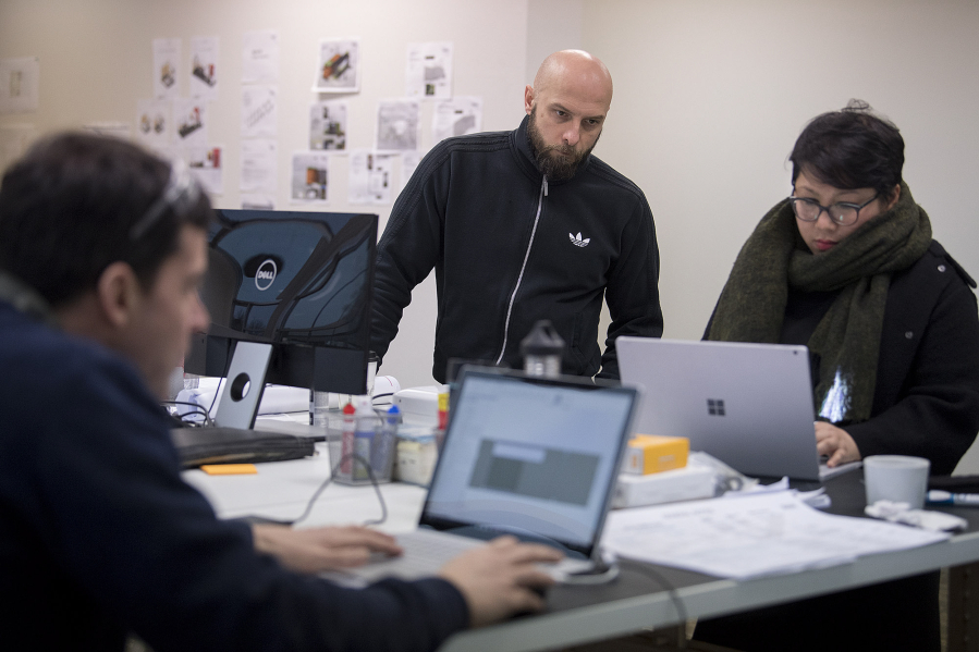 Blokable will make modular housing, in pieces sized like shipping containers, en masse beginning in April. Luke Olszewski, center, and My Tam Nguyen work in the Vancouver office on a recent Wednesday.