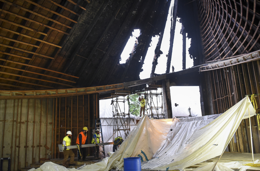 Crews with Right Manufacturing move a steel beam inside the First Congregational United Church of Christ in Hazel Dell.