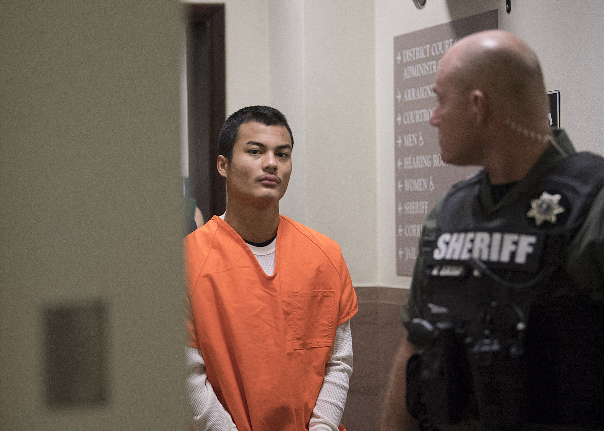 Mitchell Heng, who's accused in the Sifton Market homicide and arson last month, is escorted Wednesday morning, Feb. 1 to Clark County Superior Court to be arraigned on charges of first-degree murder, first-degree arson and first-degree robbery.