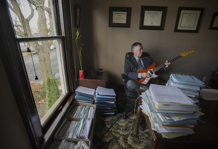 Michael Green, a Vancouver criminal defense attorney and musician, is pictured in his downtown office. Green will often take a break from his caseload for a quick jam session to help clear his mind and refocus.
