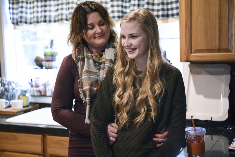 Amy Coles, left, shares a moment with her daughter, Kaylin, 13, in their home in Battle Ground. Kaylin was diagnosed with chronic kidney failure in May, and her family is searching for a living donor.