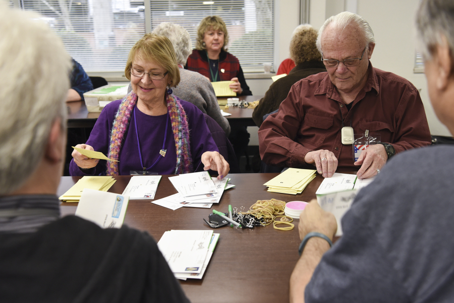 Margie Brown, left, and Gary McMann open and sort ballots at the Clark County Elections Office on Wednesday. About 180,000 registered voters are eligible to participate in this February&#039;s special election.