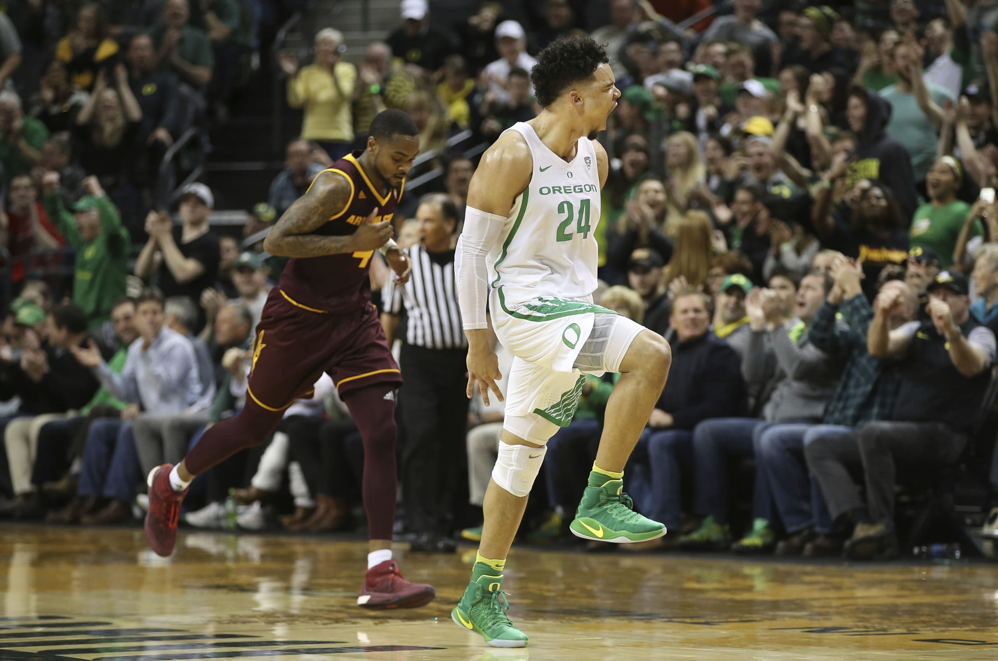 Oregon's Dillon Brooks, right, celebrates after shooting a 3-point shot in the closing minutes, as Arizona State's Torian Graham moves downcourt during an NCAA college basketball game Thursday, Feb. 2, 2017, in Eugene, Ore. Oregon won 71-70.