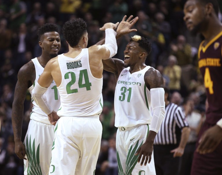 Oregon's Jordan Bell, left, Dillon Brooks and Dylan Ennis celebrate Oregon taking the lead, as Arizona State's Torian Graham leaves the court for a timeout in the closing minutes of an NCAA college basketball game Thursday, Feb. 2, 2017, in Eugene, Ore.