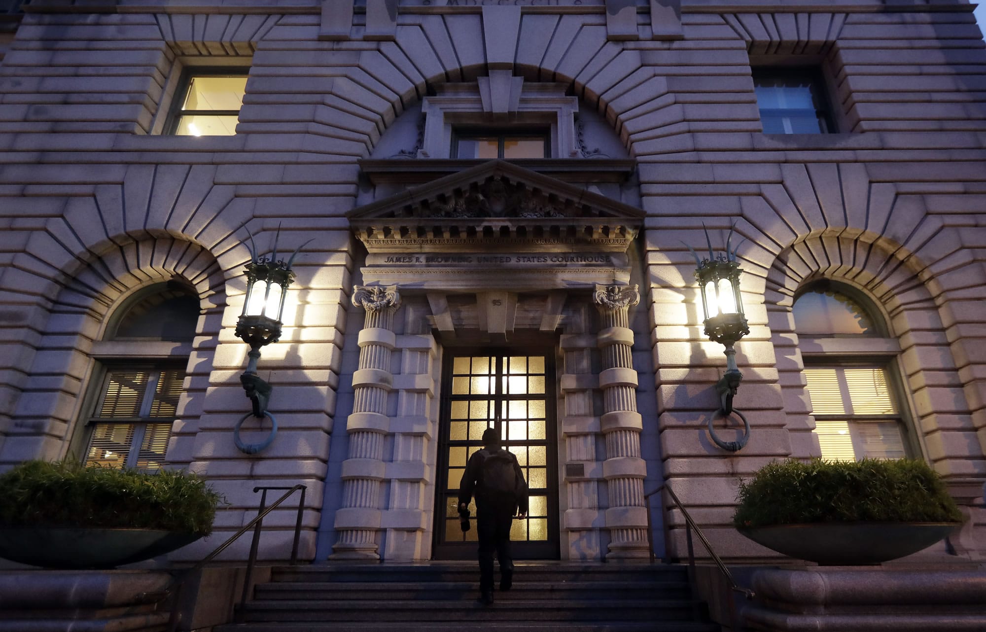 A man walks up the steps of the 9th U.S. Circuit Court of Appeals building Thursday, Feb. 9, 2017, in San Francisco. A federal appeals court refused Thursday to reinstate President Donald Trump's ban on travelers from seven predominantly Muslim nations, dealing another legal setback to the new administration's immigration policy.