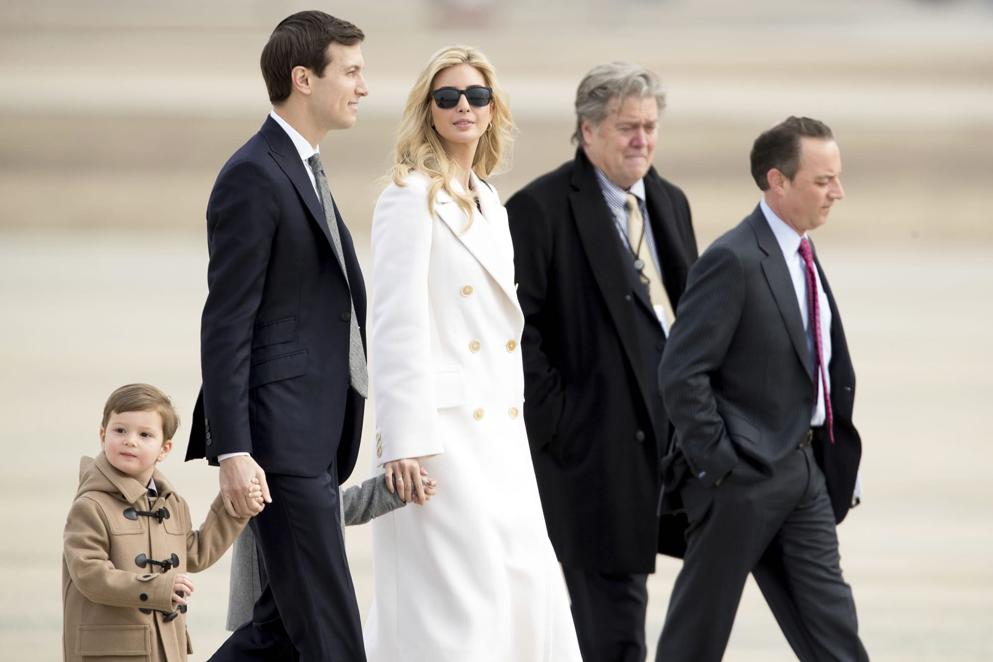 Ivanka Trump, daughter of President Donald Trump, her husband, senior adviser Jared Kushner, their two children Arabella Kushner and Joseph Kushner, Chief White House Strategist Steve Bannon, second from right, and Chief of Staff Reince Priebus, right, walk to Air Force One at Andrews Air Force Base in Md., Friday, Feb. 17, 2017. Trump is visiting Boeing South Carolina to see the Boeing 787 Dreamliner before heading to his estate Mar-a-Lago in Palm Beach, Fla., for the weekend.