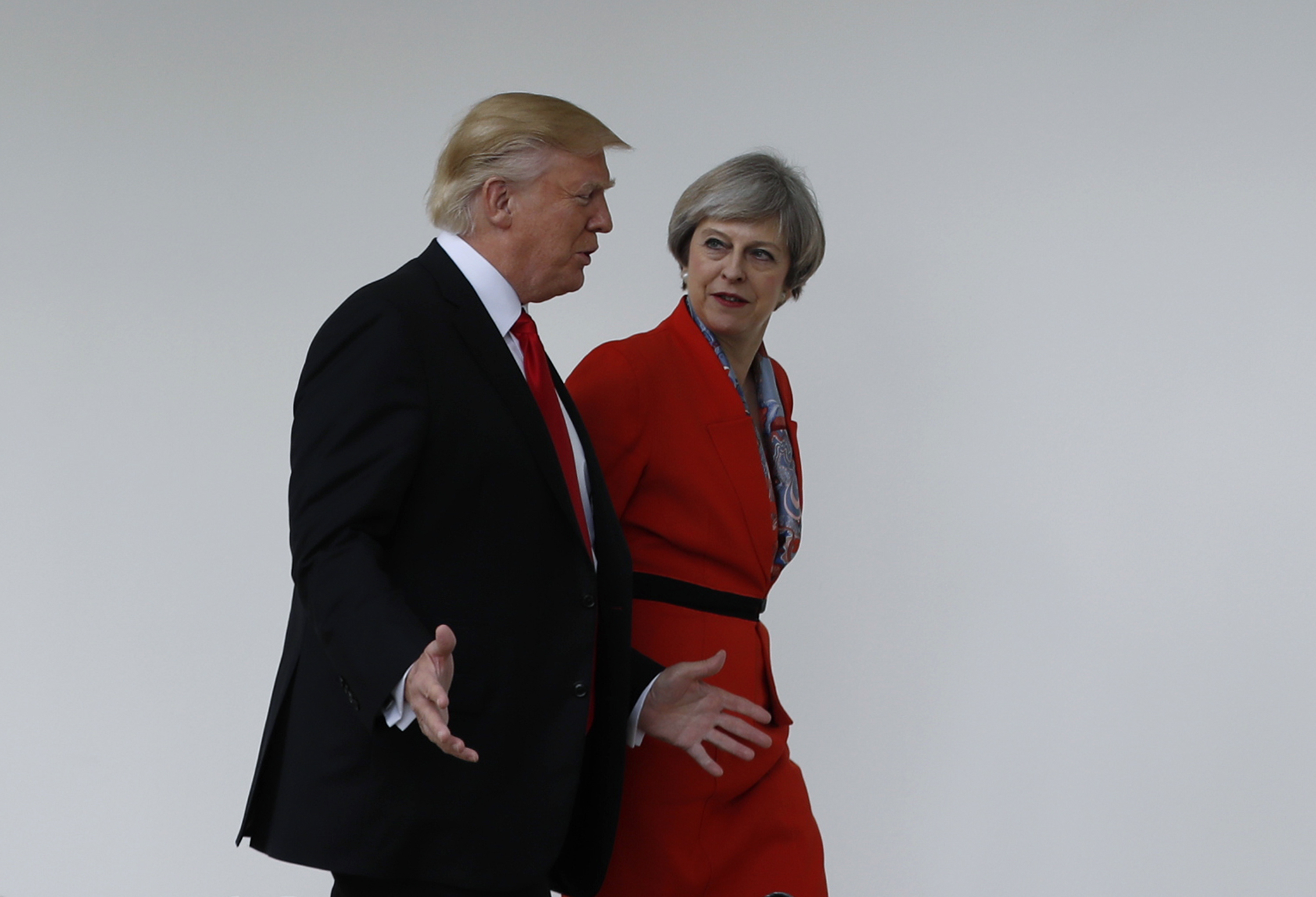 FILE - In this file photo dated Friday, Jan. 27, 2017, US President Donald Trump and Britain's Prime Minister Theresa May walk along the colonnades of the White House in Washington.  British lawmakers are set to hold a debate on Monday in London to consider a call for U.S. President Donald Trump to be denied an official state visit to the U.K., but the Conservative government insists the invitation remains firmly in place.