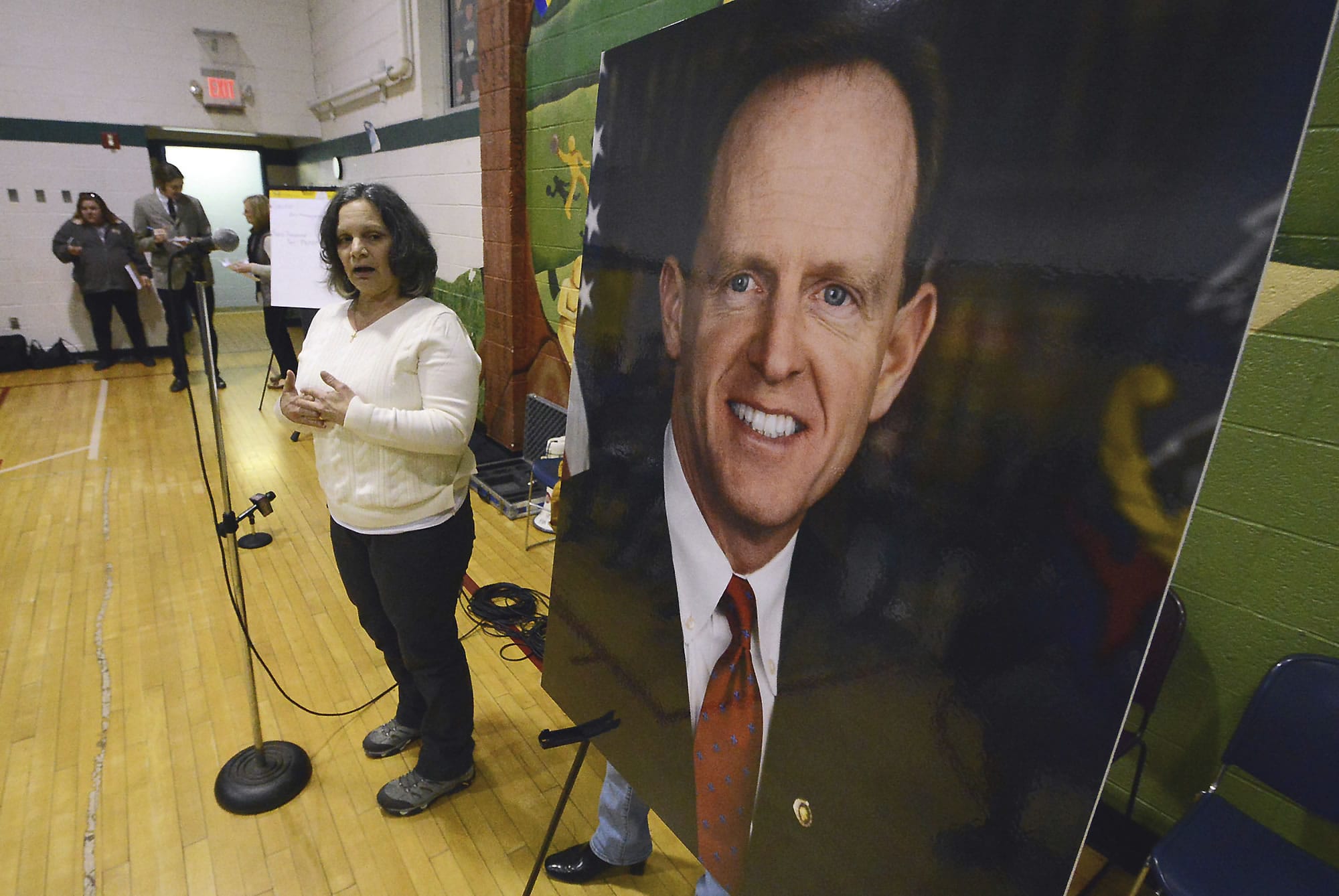 Anna Washick, of Thornhurst, Pa., tells her story regarding health care next to a large photograph of Sen. Pat Toomey, R-Pa., at the United Neighborhood Center in Scranton, Pa., Tuesday, Feb. 21, 2017. Toomey was invited to speak at the town hall, but did not attend.