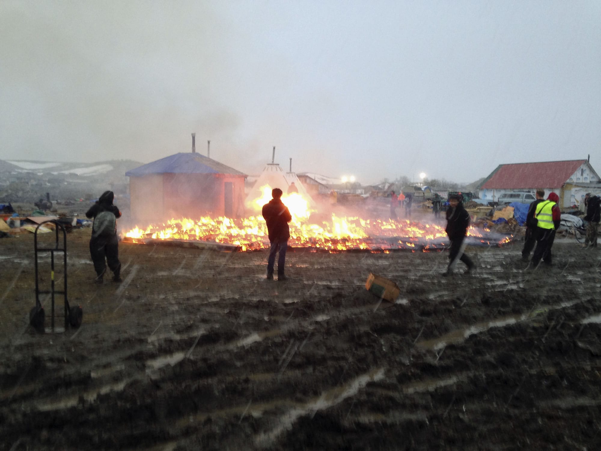 Dakota Access pipeline opponents burn structures in their main protest camp in southern North Dakota near Cannon Ball, N.D., on Wednesday, Feb. 22, 2017, as authorities prepare to shut down the camp in advance of spring flooding season.