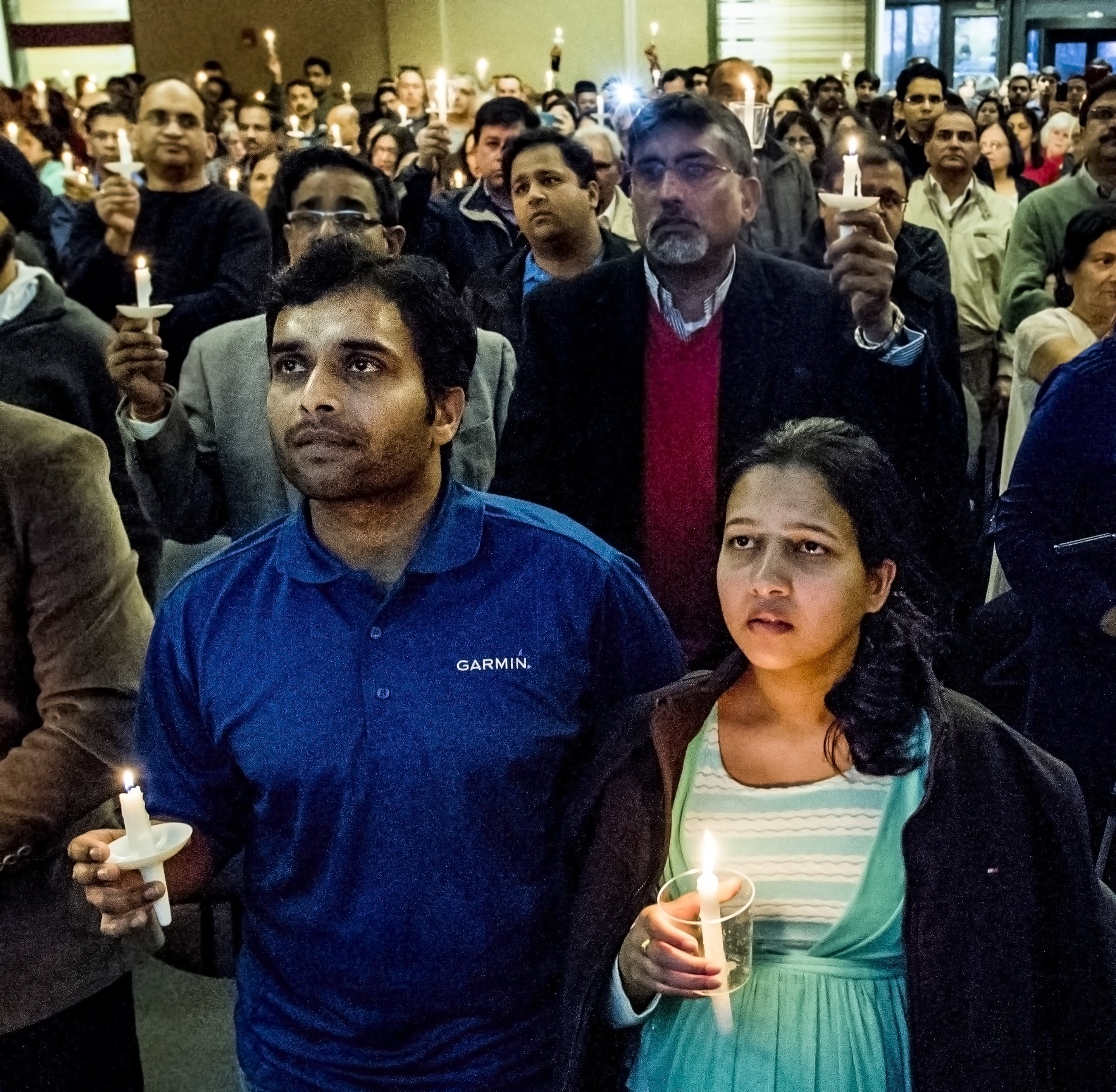 Alok Madasani, left, and his wife Reepthi Gangula hold candles during a vigil Sunday, Feb. 26, 2017, at the Ball Conference Center in Olathe, Kan., held in response to the deadly shooting Wednesday. Adam Purinton was arrested hours after the attack and accused of shooting two Indian immigrants and a third man at a bar, in what some believe was a hate crime. Alok Madasani was injured during the attack.