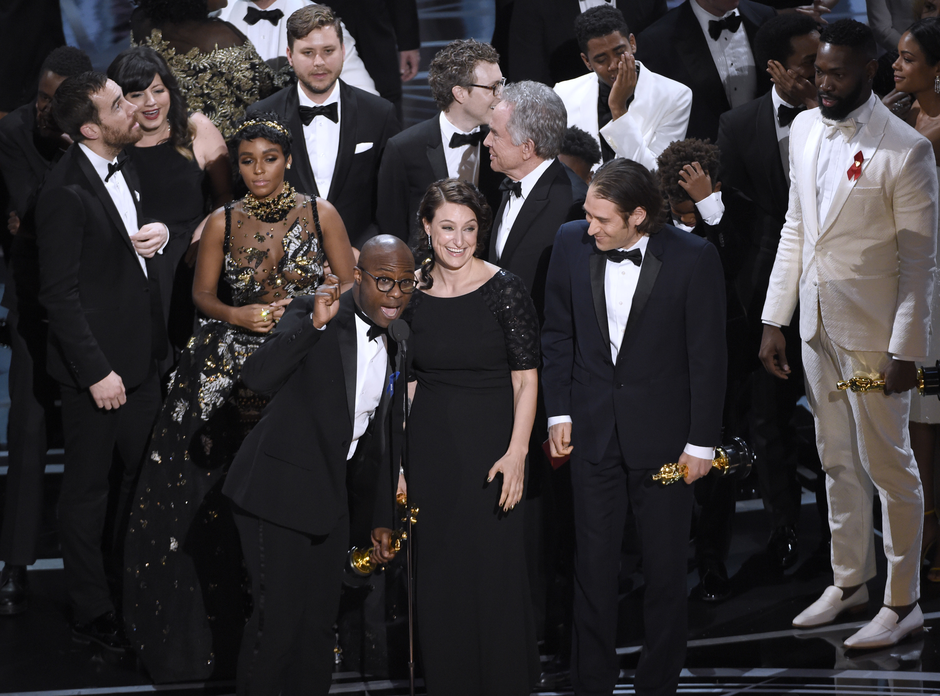 Barry Jenkins, foreground left, and the cast accept the award for best picture for "Moonlight" at the Oscars on Sunday, Feb. 26, 2017, at the Dolby Theatre in Los Angeles.