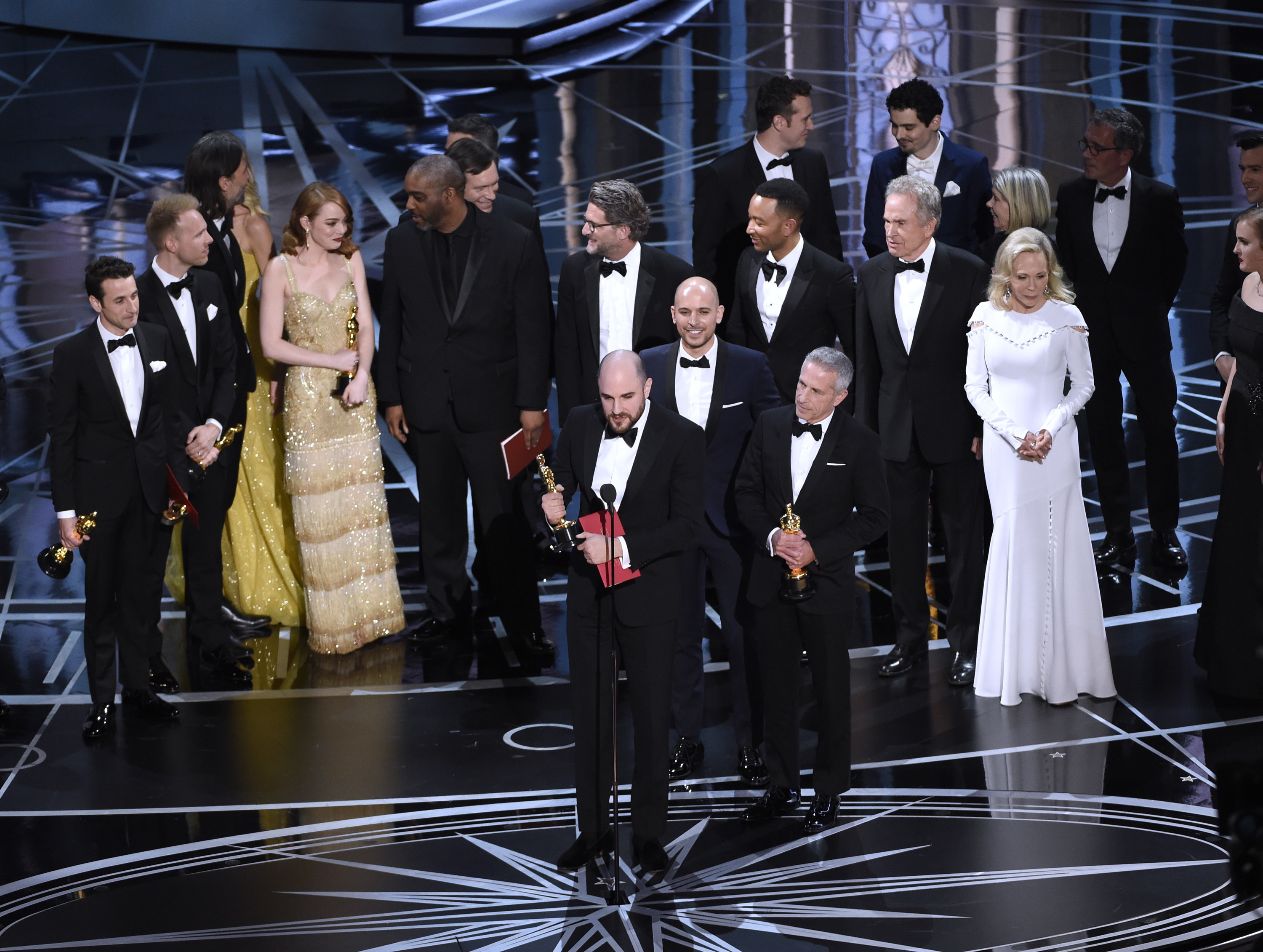 Jordan Horowitz, foreground center, and the cast of "La La Land" mistakenly accept the award for best picture at the Oscars on Sunday, Feb. 26, 2017, at the Dolby Theatre in Los Angeles. It was later announced that "Moonlight," was the winner for best picture.