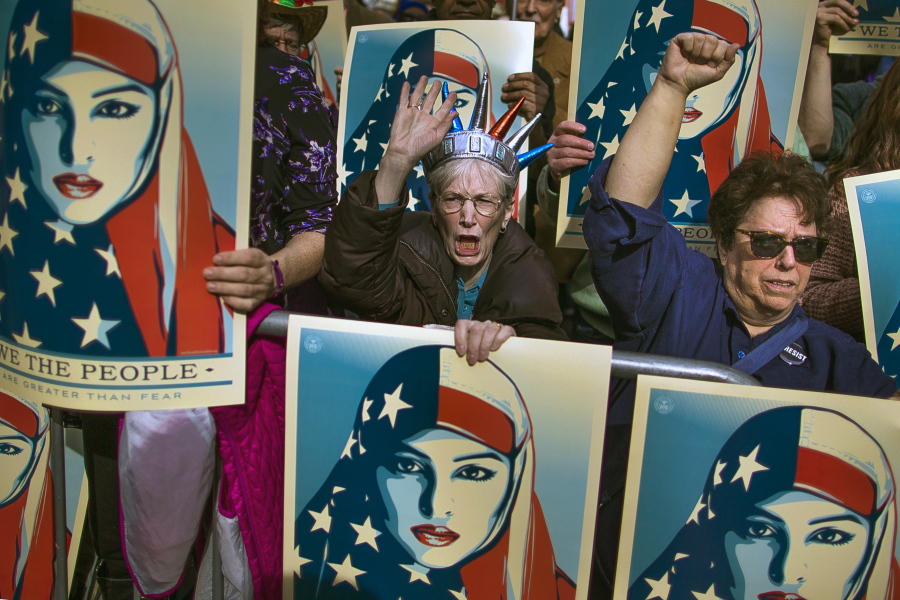 People carry posters during a rally against President Donald Trump&#039;s executive order banning travel from seven Muslim-majority nations, in New York&#039;s Times Square, Sunday, Feb. 19, 2017.