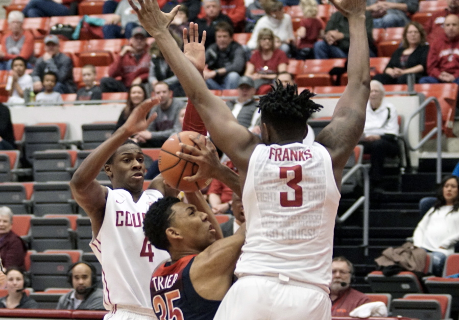 Arizona forward Allonzo Trier (35) tries to shoot between Washington State defenders Viont&#039;e Daniels (4) and Robert Franks (3) in the first half of an NCAA college basketball game, Thursday, Feb. 16, 2017, in Pullman, Wash.