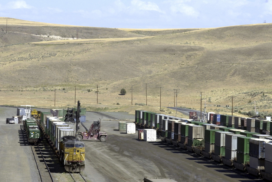 FILE--In this Aug. 3, 2004, file photo, garbage, hauled in by train, is unloaded onto trucks for transfer to the Arlington landfill, which is one of Gilliam County&#039;s biggest employers, in the barren, rolling hills near Arlington, Ore. The landfill faces an uncertain future, however, as Portland, Ore., now considers different alternatives for disposing of its solid waste. If that happens, it may cost jobs and significant revenue for Gilliam County, which uses host fees from Columbia Ridge to help pay for things like roads, small business loans and tax rebates for homeowners.