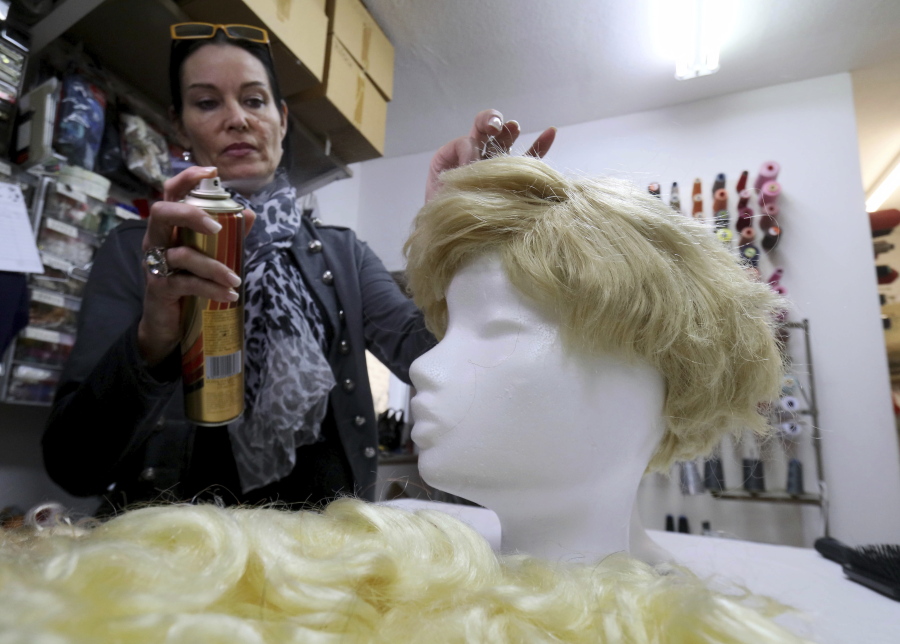 Manuela Plank owner of a costume rental shop fashioning normal blond hairpieces into Trump wigs in Pfaffstaetten, Austria, on Monday. Just about everyone wants to be Donald Trump this carnival season in Austria _ so much so that some costume rentals are out of stock of wigs miming the U.S. president&#039;s signature hairstyle.