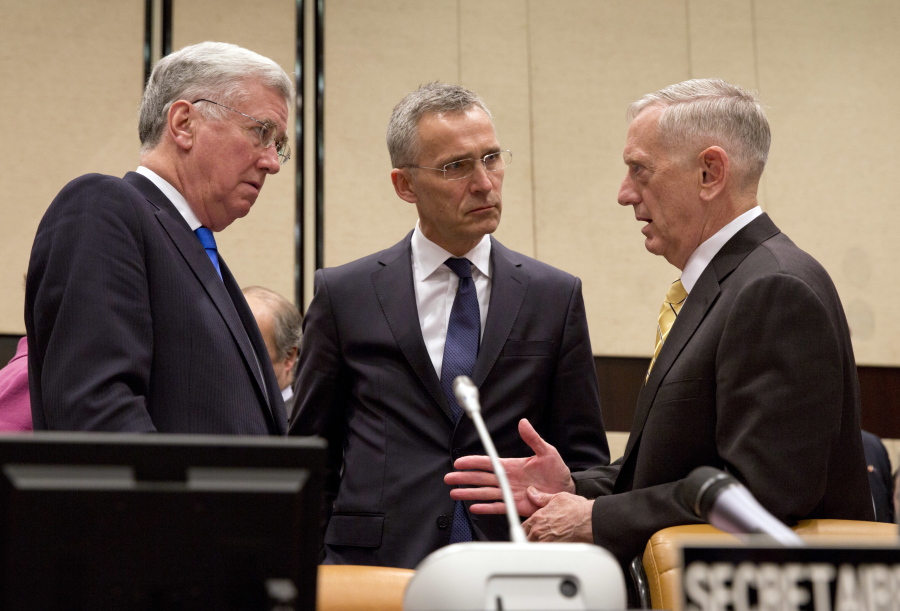 U.S. Secretary of Defense Jim Mattis, right, NATO Secretary General Jens Stoltenberg, center, and British Secretary of State for Defense Michael Fallon, left, speak prior to a meeting of the counter-Islamic State Coalition at NATO headquarters in Brussels on Thursday, Feb. 16, 2017. Allies and their partners met on Thursday to talk about accelerating efforts to fight Islamic State militants.