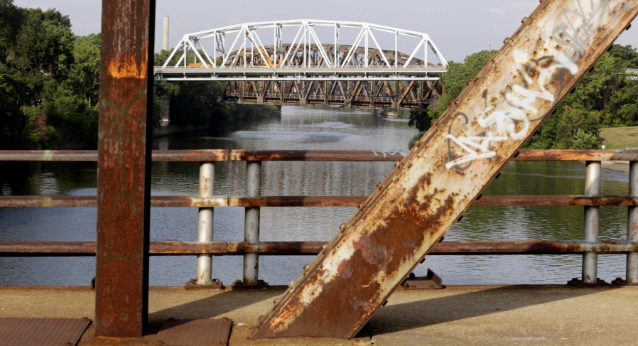 The bridge on Western Avenue over the Cal-Sag Channel in Blue Island, Ill., framed by the rusted supports of the closed Chatham Street bridge, is classified as both &quot;structurally deficient&quot; and &quot;fracture critical&quot; in federal data for 2012.