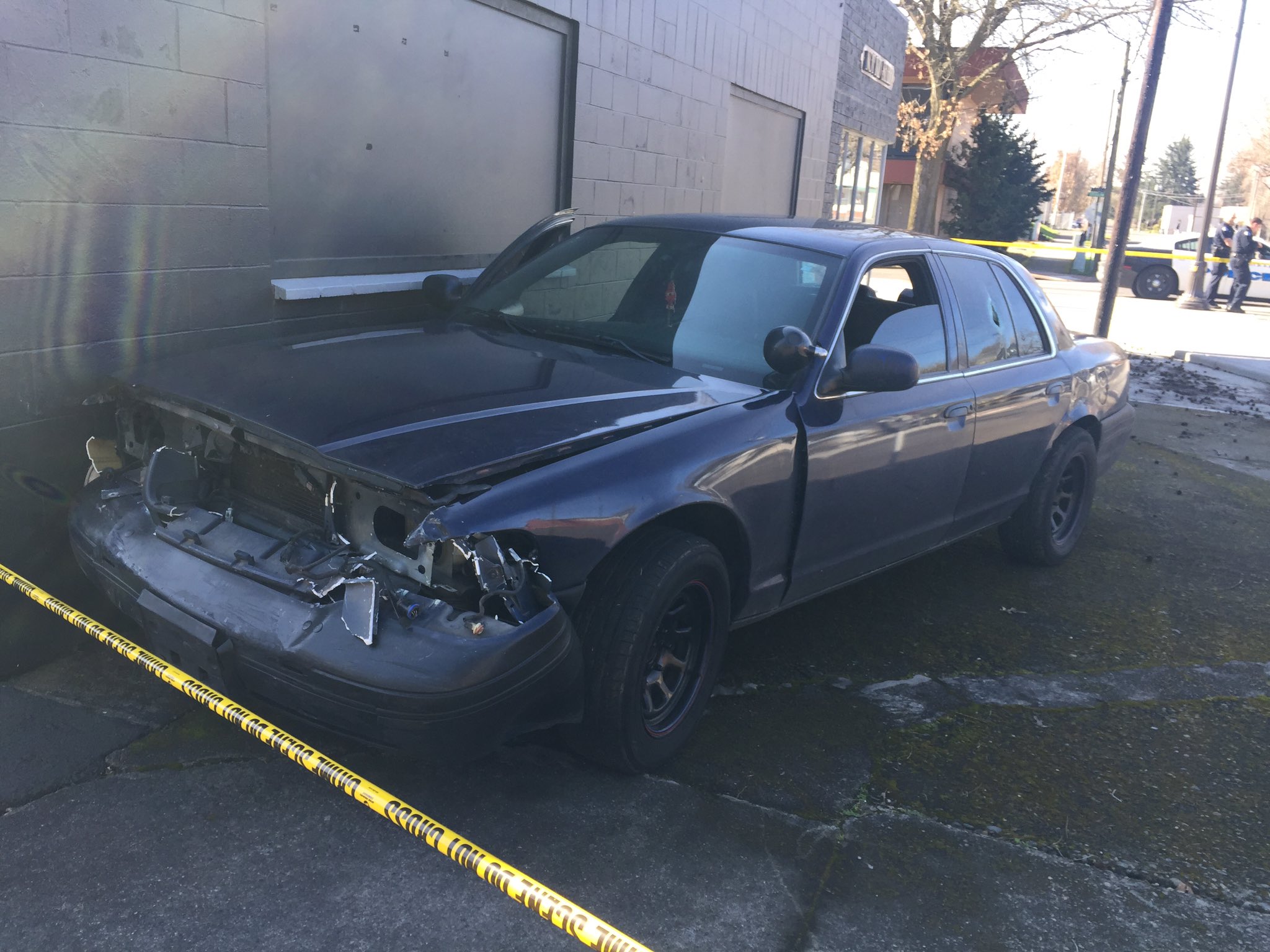 A car that was apparently involved in Saturday's police shooting shows damage after it crashed several blocks away.