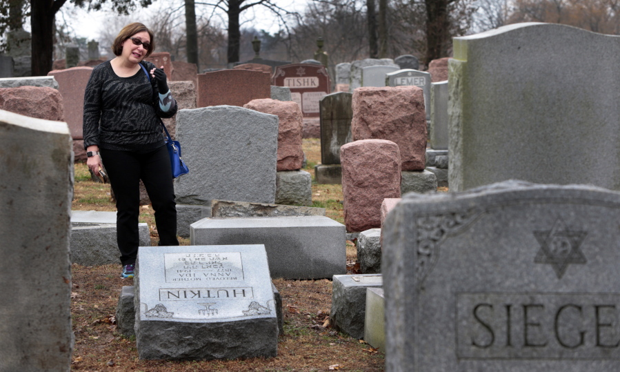Sally Amon of Olivette, Mo., reacts as she saw toppled gravestone of her grandmother Anna Ida Hutkin at Chesed Shel Emeth Cemetery in University City, a suburb of St. Louis on Tuesday. Vandals have damaged or tipped over as many as 200 headstones at the Jewish cemetery in suburban St. Louis, leaving the region&#039;s Jewish community shaken and anxious. (Robert Cohen/St.