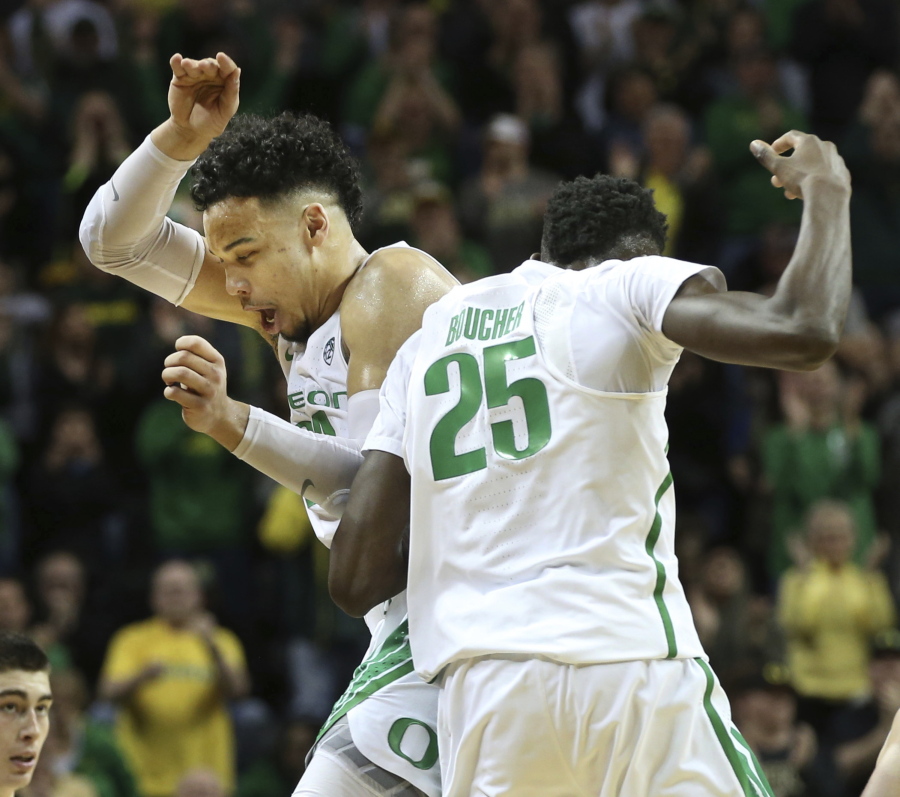 Oregon&#039;s Dillon Brooks, left, and Chris Boucher celebrate as Colorado calls timeout after a Boucher three-point shot during the second half of an NCAA college basketball game Saturday, Feb. 18, 2017, in Eugene, Ore.