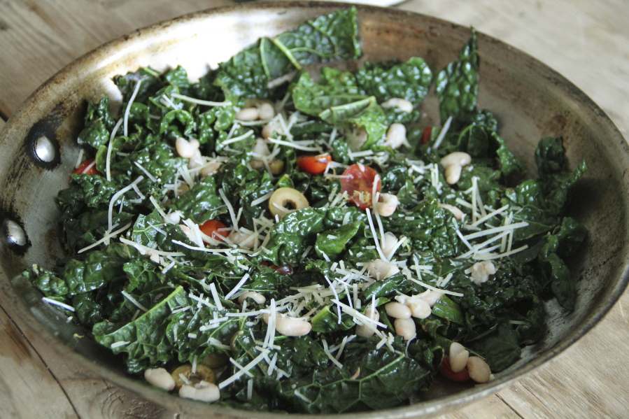 Tuscan kale sauteed with anchovies, olives, tomatoes and white beans (Melissa d&#039;Arabian via AP)