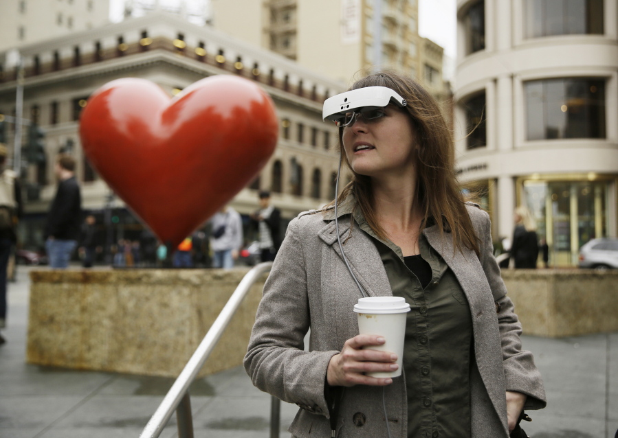 Yvonne Felix looks around San Francisco&#039;s Union Square with eSight electronic glasses Feb. 2. The artist, who was diagnosed with Stargardt&#039;s disease after being hit by a car at age 7, can now see the faces of her husband and sons.