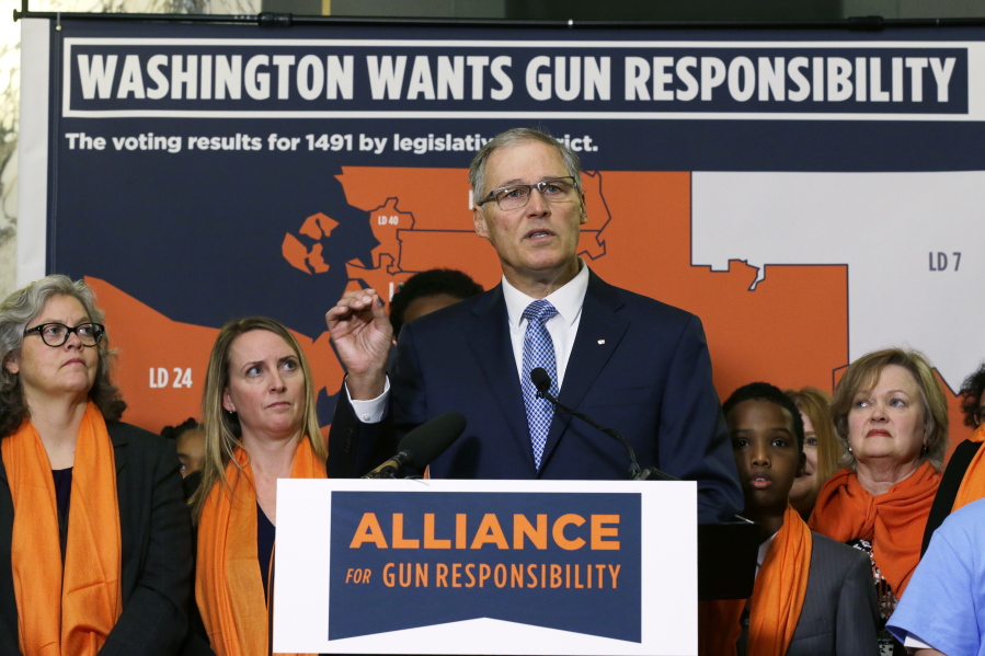 Washington Gov. Jay Inslee speaks Thursday at the Capitol in Olympia. Inslee was urging the passage of bills enforcing safe gun storage and enhanced background checks when buying or selling assault weapons. (AP Photo/Ted S.