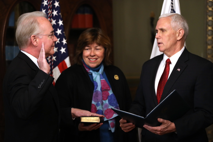 Vice President Mike Pence administers the oath of office to Health and Human Services Secretary Tom Price, accompanied by his wife, Betty, on Friday in the in the Eisenhower Executive Office Building on the White House complex in Washington.