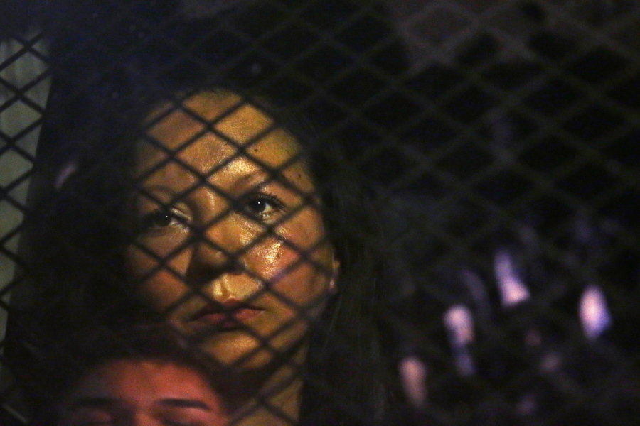 Guadalupe Garcia de Rayos sits locked in a van, stopped in the street Wednesday by protesters in Phoenix before she was swiftly deported to Mexico.
