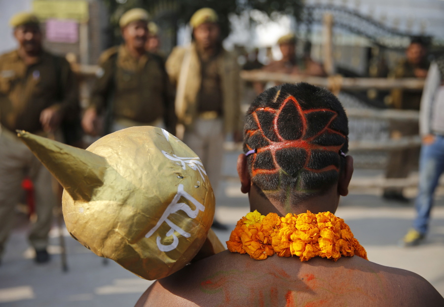 In this Friday, Feb. 3, 2017 photo, a supporter of India&#039;s ruling Hindu nationalist Bharatiya Janata Party (BJP), his head shaved in the lotus symbol of the party, holds a mace and stands in support of a candidate filing his nominations for state elections, in Allahabad, in the northern Indian state of Uttar Pradesh. In 2014, the BJP had won an overwhelming 71 out of 80 parliamentary seats in Uttar Pradesh, or 15 percent of all national legislators in the powerful lower house, ensuring that it emerged as the single largest party in Parliament. But prime minister Narendra Modi now faces a tough fight in Uttar Pradesh (UP), with the state&#039;s current top official, Akhilesh Yadav, in a political alliance with the Congress Party led by Rahul Gandhi, scion of the Nehru-Gandhi family that ruled India for decades. While elections in five states, including UP, will not decide whether Modi remains in office, a loss would be seen as a serious blow to his political image.