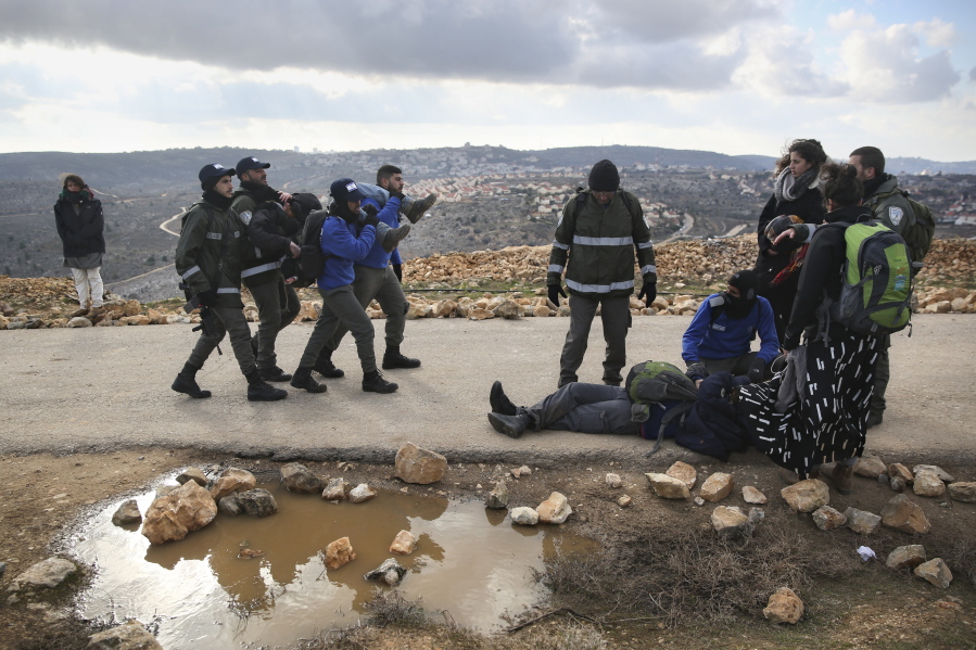 Israeli police evict settlers from the West Bank outpost of Amona on Wednesday. Israeli forces have begun evacuating a controversial settlement  Amona, which is the largest of about 100 unauthorized outposts erected in the West Bank without permission but generally tolerated by the Israeli government.