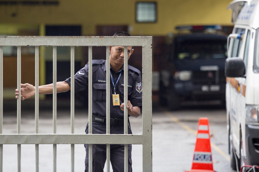 A Malaysian police officer closes the gate of the National Forensic Institute at Kuala Lumpur Hospital in Kuala Lumpur, Malaysia, Sunday, Feb. 26, 2017. Malaysian police ordered a sweep of Kuala Lumpur airport for toxic chemicals and other hazardous substances following the killing of Kim Jong Nam.