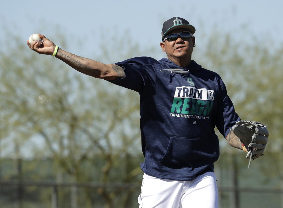 FILE - In this Feb. 15, 2017, file photo, Seattle Mariners pitcher Felix Hernandez participates in a drill during spring training baseball practice in Peoria, Ariz. Hernandez is beginning his climb back from one of his toughest seasons, when he went 11-8 with a 3.82 ERA and his lowest innings total since 2007.