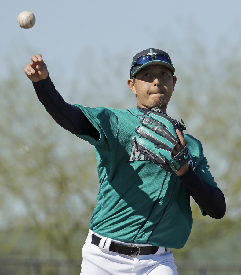 Seattle Mariners pitcher Hisashi Iwakuma throws during spring training Wednesday, in Peoria, Ariz.