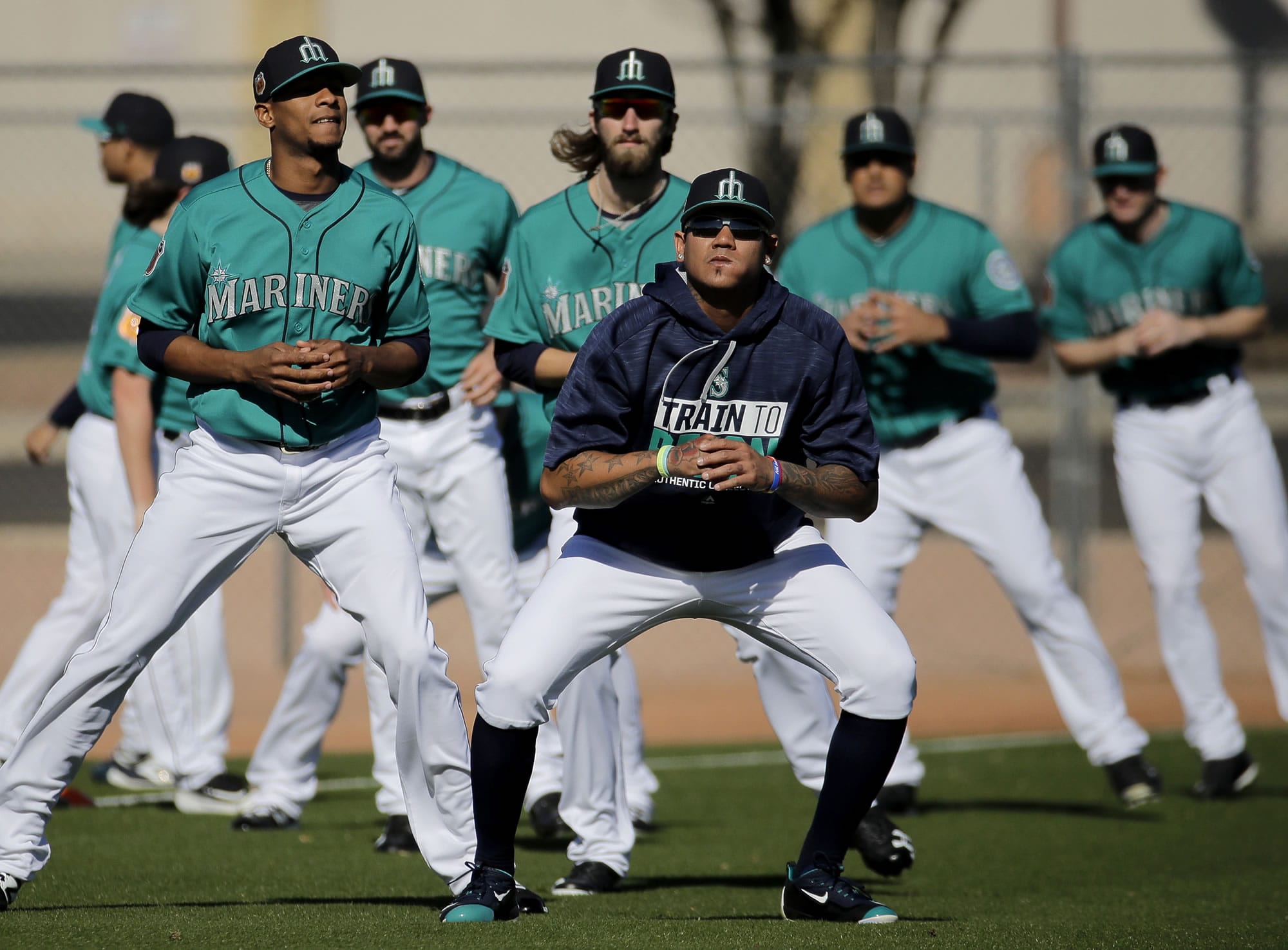 Seattle Mariners pitcher Felix Hernandez, front center, stretches with teammates participates during spring training baseball practice Wednesday, Feb. 15, 2017, in Peoria, Ariz.