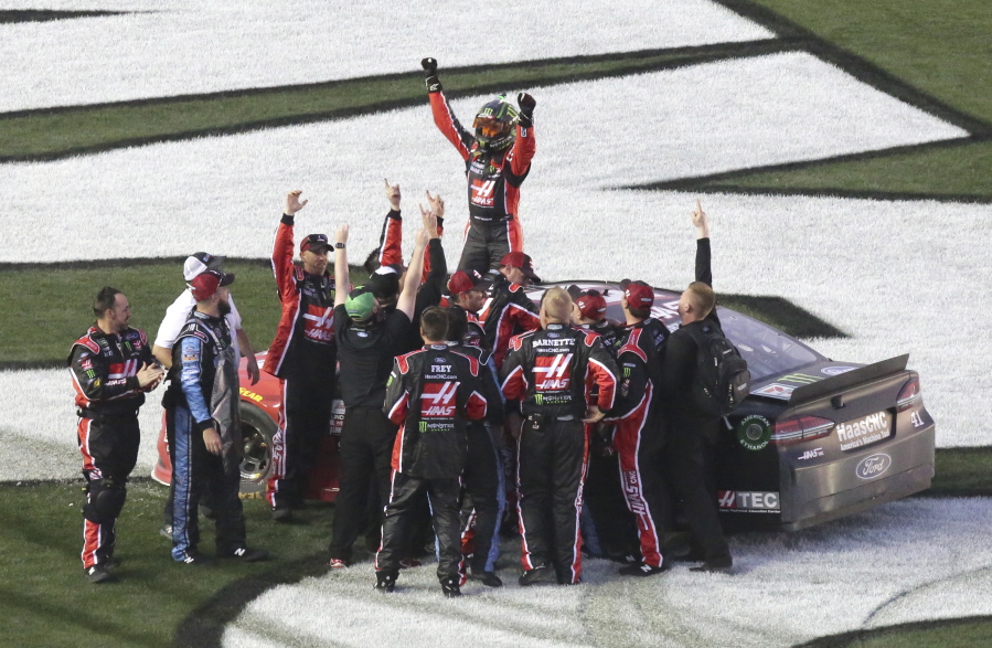 Kurt Busch, top, celebrates with crew members after winning the NASCAR Daytona 500 auto race at Daytona International Speedway in Daytona Beach, Fla., Sunday, Feb. 26, 2017.